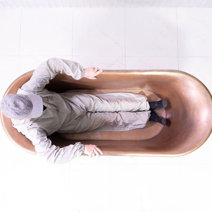 Body height comparison showing a person in “SanSiro Colmar 67HLAA” Heated Air Jetted 67" Freestanding Hammered Copper Tub