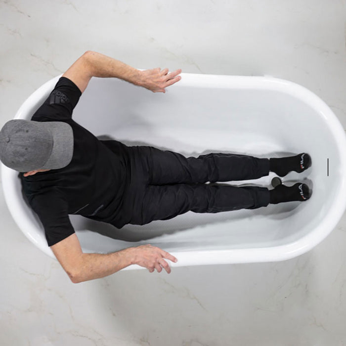 Body height comparison showing a person in 58" x 33" Clawfoot Tub “Calypso Athena 58ACHCL” CoreAcryl Acrylic in Aged Chrome Finish